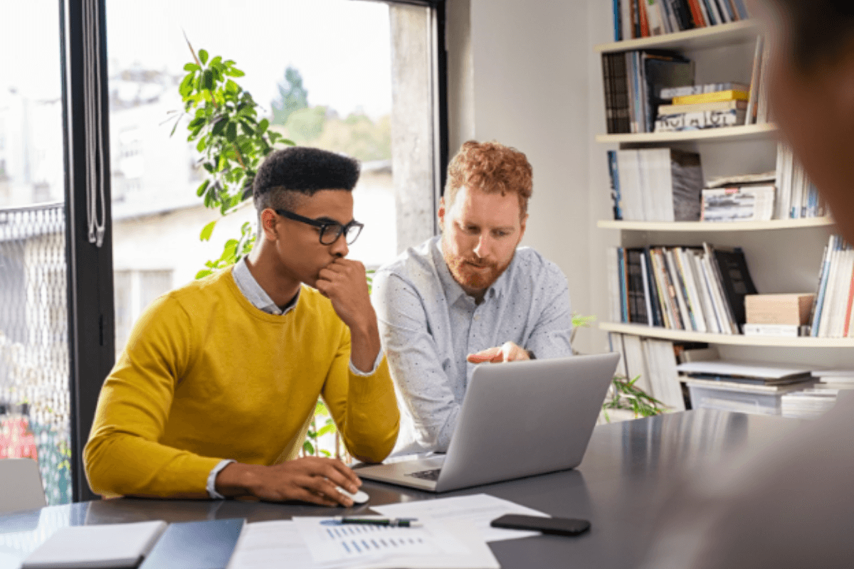 two men lookig at computer